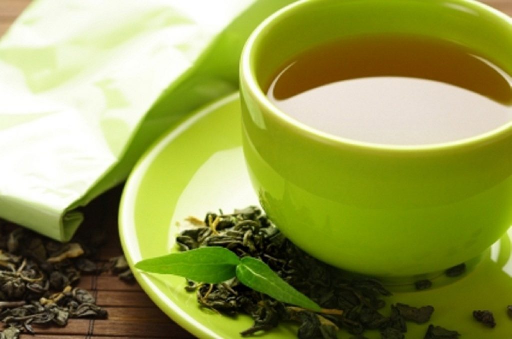 healthy green tea cup with tea leaves